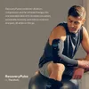 A man is sitting on an exercise ball wearing a compression sleeve on his arm. Podgląd zdjęcia produktu