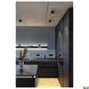 A modern, minimalist kitchen with dark cabinetry and concrete ceiling, featuring recessed lighting. Produktbild-Vorschau