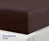 A close-up view of a brown fitted sheet on a white bed frame. Produktbild-Vorschau