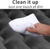 A hand is wiping a dark gray, textured surface with a white cloth. Text overlays indicate ease of cleaning. Náhled obrázku produktu