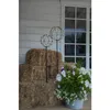 Two LED decorative spheres on stakes are placed next to hay bales and a pot of flowers on a porch. Produktbild-Vorschau