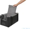 A hand is shown placing a gray cushion into a black dog car seat. Produktbild-Vorschau