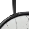 Close-up of the connection between a metal leg and the edge of a round table with a marble-like pattern. Produktbild-Vorschau