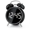 A black retro-style alarm clock with a digital display showing the time. Náhled obrázku produktu