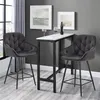 Two gray bar stools are placed around a narrow bar table with two wine glasses and a bottle of wine on it. The scene is set in a room with gray walls and a window with gray curtains. Produktbild-Vorschau