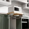A white microwave oven sits on a pull-out wooden shelf installed above green kitchen cabinets. Podgląd zdjęcia produktu