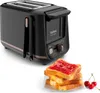 A black Tefal toaster with bronze accents, positioned diagonally with slices of toast topped with jam in the foreground and some cherries to the side. Voir les images du produit