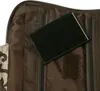 A close-up view of the inside of a toiletry bag, showing a black rectangular object placed on brown fabric. Anteprima dell’immagine prodotto