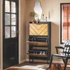 An entryway with a shoe cabinet, a chair, and a door. Produktbild-Vorschau