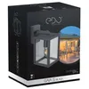 The image shows the packaging of an outdoor wall lamp. The packaging features a picture of the lamp installed on a house exterior, along with product details and branding. Anteprima dell’immagine prodotto