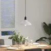 A dining table set with plates, glasses, and a vase of eucalyptus, under a white pendant light. Náhľad obrázku produktu