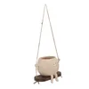 A hanging planter shaped like a cartoon character sitting on a swing. Anteprima dell’immagine prodotto