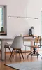 A modern dining room setting with a pendant light fixture over a table and chairs. Anteprima dell’immagine prodotto