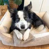 A dog is lying comfortably in a dog bed. Náhled obrázku produktu