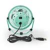 The back view of a small, teal-colored USB desk fan is shown against a white background. The fan has a metal grill, a power switch, and a black USB cable. Podgląd zdjęcia produktu