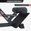 A close-up view of a black fitness machine, highlighting its padded leg support and non-slip rubber foot. Produktbild-Vorschau