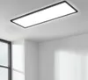 A rectangular LED panel light is mounted on a white ceiling in a room with white walls and a large window. Anteprima dell’immagine prodotto