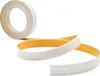 A roll of white self-adhesive trim tape with a yellow adhesive backing is shown, with a section unrolled and curved. Produktbild-Vorschau