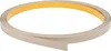 A roll of beige flat profile trim with adhesive backing, coiled on a white background. Anteprima dell’immagine prodotto