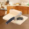 A kitchen counter with a bread slicer and a basket of bread in the background. Náhled obrázku produktu