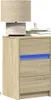 A wooden nightstand with a lamp and a cup on top. Produktbild-Vorschau