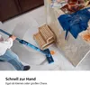 A person is using a blue electric mop to clean up an orange spill on a tiled floor in a kitchen. Náhled obrázku produktu
