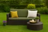 A garden bench cushion set is displayed on a lawn in a garden setting. Produktbild-Vorschau