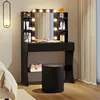 A black vanity table with LED lights and a mirror, a black stool, and a beige handbag on a shelf. Produktbild-Vorschau