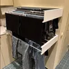 A wall-mounted clothes drying rack with laundry hanging on it, in what appears to be a laundry room or bathroom. Produktbild-Vorschau