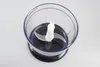 A close-up, top-down view of the chopping attachment for a blender or food processor. Voir les images du produit