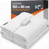 A folded white electric blanket with a controller is shown in front of its packaging. Náhled obrázku produktu