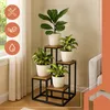 A multi-tiered plant stand with several potted plants displayed indoors. Náhľad obrázku produktu