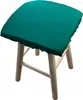 A teal stool cushion on a wooden stool. Produktbild-Vorschau