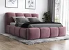 A pink upholstered bed with a headboard and footboard, set up in a bedroom with artwork on the wall and a plant in the background. Produktbild-Vorschau