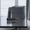 Two microphones and a charging/storage case are displayed on a reflective surface in front of blinds. Náhled obrázku produktu