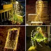 A collage of four images showcasing decorative string lights in various settings, including a garden, stacked wooden crates, a framed display, and a potted plant. Produktbild-Vorschau