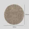 A round, beige shaggy rug is shown from a top-down view against a plain gray background. Dimensions are indicated by lines and text. Náhľad obrázku produktu