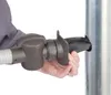 A hand is shown inserting a gray and black plastic attachment into a silver metal pipe. Náhled obrázku produktu