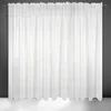 A white sheer curtain hanging against a dark gray wall and a white floor. Produktbild-Vorschau