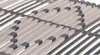 A close-up view of a wooden bed slat base with black plastic holders. Produktbild-Vorschau
