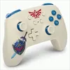 A close-up, studio shot of a cream-colored wireless Nintendo Switch controller with blue accents and The Legend of Zelda-themed decals. Anteprima dell’immagine prodotto