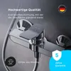 A close-up of a chrome shower faucet with text overlays highlighting quality and warranty information. Produktbild-Vorschau