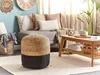 A living room scene with a pouf, sofa, coffee table, and decorative items. Náhled obrázku produktu