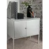 A small gray cabinet with two doors stands on a carpet. On top of the cabinet are office supplies and a vase with a plant. Produktbild-Vorschau