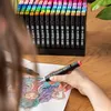 A person is coloring a detailed drawing with marker pens. Náhľad obrázku produktu