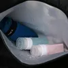 Inside of a bag with toiletries and a towel. Produktbild-Vorschau