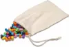 A drawstring bag with colorful cylindrical pieces spilling out onto a white surface. Produktbild-Vorschau