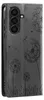 A close-up of a black smartphone case with a dandelion design. Produktbild-Vorschau
