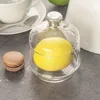 A glass bowl with a lemon inside and a macaron next to it, on a gray surface. Anteprima dell’immagine prodotto