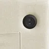 A close-up view of a black button on cream-colored fabric, with a stitched pocket visible. Podgląd zdjęcia produktu